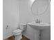 Elegant half bath with pedestal sink, modern fixtures, and neutral decor at 5208 Rolling Meadow Blvd, Indianapolis, IN 46237