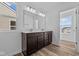 Bathroom featuring double sink vanity, wood flooring and mirror at 5208 Rolling Meadow Blvd, Indianapolis, IN 46237