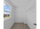 Walk-in closet features built-in shelving and a bright window overlooking the neighborhood at 5208 Rolling Meadow Blvd, Indianapolis, IN 46237