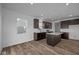 Modern kitchen featuring dark cabinetry, a center island, and stainless steel appliances at 5208 Rolling Meadow Blvd, Indianapolis, IN 46237
