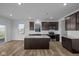 Bright kitchen featuring stainless steel appliances, a central island, and view of the yard at 5208 Rolling Meadow Blvd, Indianapolis, IN 46237