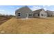 Back exterior view of the house with large backyard at 5211 Rolling Meadow Blvd, Indianapolis, IN 46237