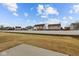 Large backyard with a concrete patio and a white fence at 5211 Rolling Meadow Blvd, Indianapolis, IN 46237