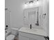 Bright bathroom with a white vanity, quartz countertop, and updated fixtures at 5211 Rolling Meadow Blvd, Indianapolis, IN 46237