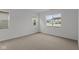 Well-lit bedroom features neutral carpet, white walls, and several windows at 5211 Rolling Meadow Blvd, Indianapolis, IN 46237