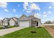 Beautiful gray home with a two-car garage and a freshly planted tree at 5211 Rolling Meadow Blvd, Indianapolis, IN 46237