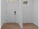 Bright foyer with hardwood floors and a white door at 5211 Rolling Meadow Blvd, Indianapolis, IN 46237