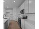 Well-equipped kitchen features stainless steel appliances, white cabinets, and quartz countertops at 5211 Rolling Meadow Blvd, Indianapolis, IN 46237