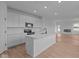 Bright, open kitchen features white cabinets, stainless appliances, and an island with breakfast bar at 5211 Rolling Meadow Blvd, Indianapolis, IN 46237