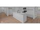 Modern kitchen with white cabinets, a kitchen island, and stainless steel appliances at 5211 Rolling Meadow Blvd, Indianapolis, IN 46237