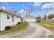 Spacious backyard with a long driveway, detached garage, and ample green space at 5225 S Linwood Ave, Indianapolis, IN 46237