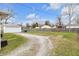 Large backyard featuring a detached garage, gravel driveway, and wooden fence perimeter at 5225 S Linwood Ave, Indianapolis, IN 46237