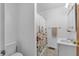 Clean bathroom featuring a floral shower curtain, white sink vanity, and neutral tile flooring at 5225 S Linwood Ave, Indianapolis, IN 46237