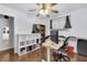 Bedroom with hardwood floors, a home office area, natural light, and storage at 5225 S Linwood Ave, Indianapolis, IN 46237