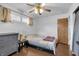Cozy bedroom features hardwood floors, a ceiling fan, and a comfortable bed with neutral tones at 5225 S Linwood Ave, Indianapolis, IN 46237