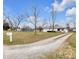 Quaint home with long gravel driveway, mature trees, and a mailbox out front at 5225 S Linwood Ave, Indianapolis, IN 46237