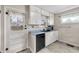 Charming kitchen featuring white cabinets, modern black sink, and a bright window view at 5225 S Linwood Ave, Indianapolis, IN 46237