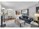 Inviting living area with a modern gray couch, hardwood floors, and natural light at 5225 S Linwood Ave, Indianapolis, IN 46237