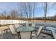 Backyard pool deck area featuring a glass table, six chairs, and an inground swimming pool at 5607 Regency Dr, Columbus, IN 47203