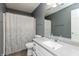 Cozy bathroom featuring a shower with white patterned curtain and grey walls with a single sink vanity at 5607 Regency Dr, Columbus, IN 47203