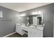 Ensuite bathroom with double sink vanity, plentiful cabinets, and large mirror at 5607 Regency Dr, Columbus, IN 47203