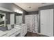Ensuite bathroom featuring single sink vanity and framed mirror, with a shower tub combination at 5607 Regency Dr, Columbus, IN 47203