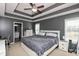 Spacious main bedroom featuring trey ceiling with ceiling fan, large windows, and ensuite bathroom at 5607 Regency Dr, Columbus, IN 47203