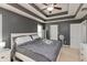 This main bedroom features trey ceiling with ceiling fan, natural light from the large windows, and neutral carpet at 5607 Regency Dr, Columbus, IN 47203