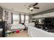 Secondary bedroom featuring two twin beds, a ceiling fan, and windows for natural light at 5607 Regency Dr, Columbus, IN 47203