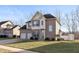Two-story home featuring a well-manicured lawn, attached two car garage and neutral brick and tan siding at 5607 Regency Dr, Columbus, IN 47203
