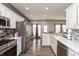 Modern kitchen with white cabinets, stainless appliances and an open view to the living spaces at 5607 Regency Dr, Columbus, IN 47203