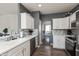 Bright and modern kitchen featuring white cabinets, tile backsplash, and stainless steel appliances at 5607 Regency Dr, Columbus, IN 47203