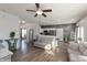 Open concept living room showcasing hardwood flooring, ceiling fan, and views of the kitchen area at 5607 Regency Dr, Columbus, IN 47203