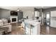 Open concept view of the living room with fireplace and kitchen with eat in bar at 5607 Regency Dr, Columbus, IN 47203