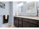 Updated bathroom with double vanity featuring granite countertops, dark cabinets, and modern fixtures at 5658 Pecan Ct, Noblesville, IN 46062