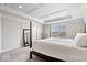 Spacious bedroom featuring a tray ceiling, panel walls, a large window, and neutral decor at 5658 Pecan Ct, Noblesville, IN 46062