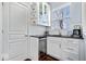Wet bar includes a beverage fridge, cabinets, open shelving, tile backsplash, and countertop at 5658 Pecan Ct, Noblesville, IN 46062