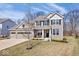 Charming two-story home boasts a manicured lawn, stone accents, and attached two car garage at 5658 Pecan Ct, Noblesville, IN 46062