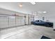 Spacious three-car garage featuring two white doors and a blue Trans Am at 5658 Pecan Ct, Noblesville, IN 46062
