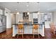 Modern kitchen with white cabinets, stainless steel appliances, and a large center island at 5658 Pecan Ct, Noblesville, IN 46062