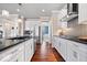Modern kitchen with white cabinets, stainless steel appliances, and a gray tile backsplash at 5658 Pecan Ct, Noblesville, IN 46062
