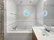 Bathroom with a large tub, a white vanity, and unique window at 603 Raintree Dr, Avon, IN 46123