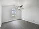 Bright bedroom featuring plush carpet, a ceiling fan and a large arched window at 603 Raintree Dr, Avon, IN 46123