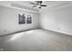 Spacious bedroom featuring plush carpet, a ceiling fan, and ample natural light at 603 Raintree Dr, Avon, IN 46123