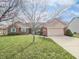 Charming single-story home with a well-manicured lawn and attached two car garage at 603 Raintree Dr, Avon, IN 46123
