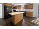 Functional kitchen with center island, wood cabinets, and black appliances at 603 Raintree Dr, Avon, IN 46123