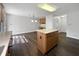 Open kitchen with an island, dark wood floors, and eat-in area at 603 Raintree Dr, Avon, IN 46123