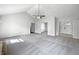 Bright living room featuring vaulted ceilings, plush carpet and entry to dining room at 603 Raintree Dr, Avon, IN 46123