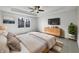 A relaxing main bedroom with large window, ceiling fan, dresser, and soft, neutral tones at 603 Raintree Dr, Avon, IN 46123