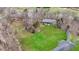 Aerial view showing the property size, lawn, and surrounding wooded area at 7023 Mustang Ct, Martinsville, IN 46151
